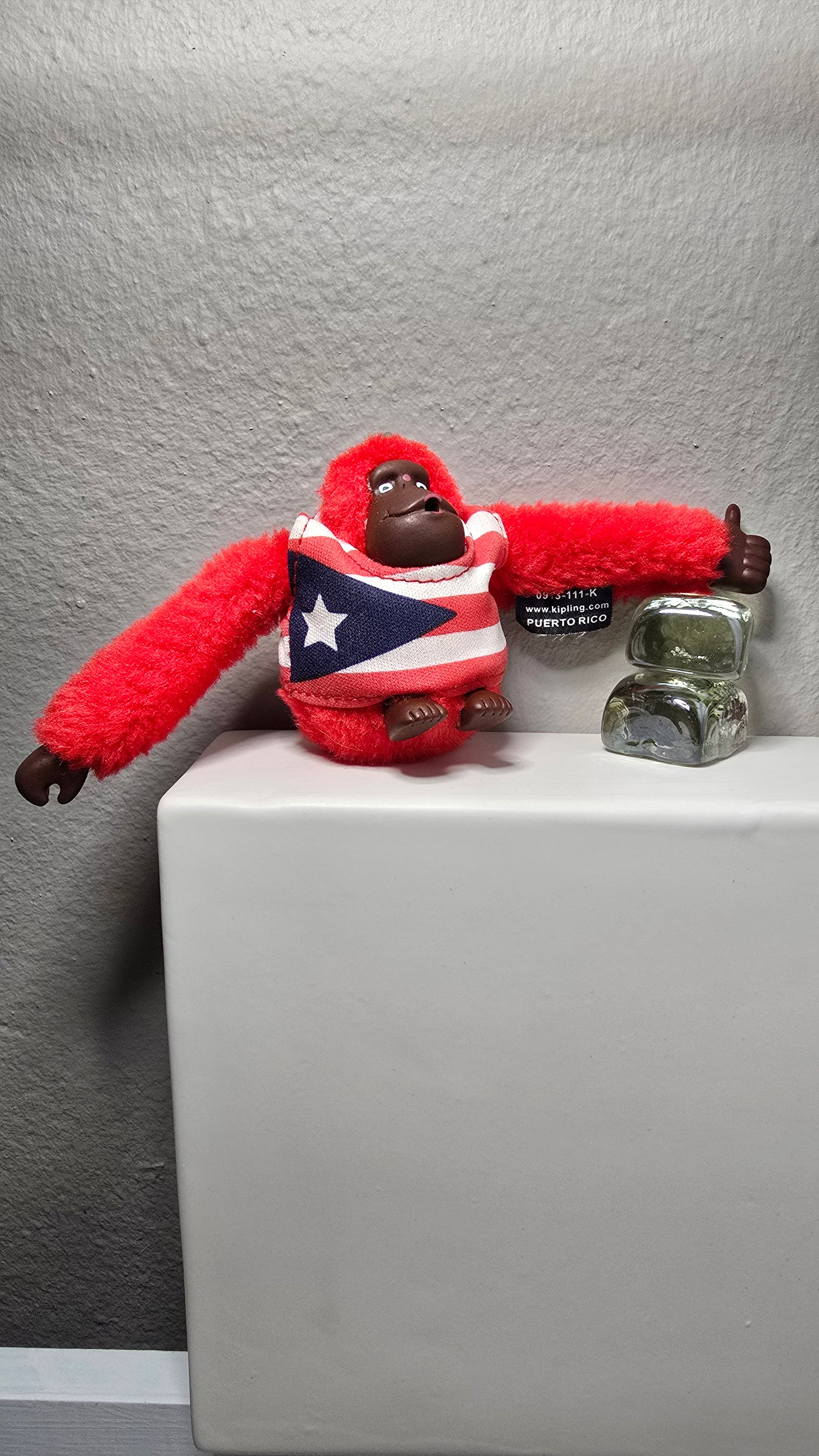 Kipling Red Fuzzy Monkey Keychain with Puerto Rico Flag Shirt