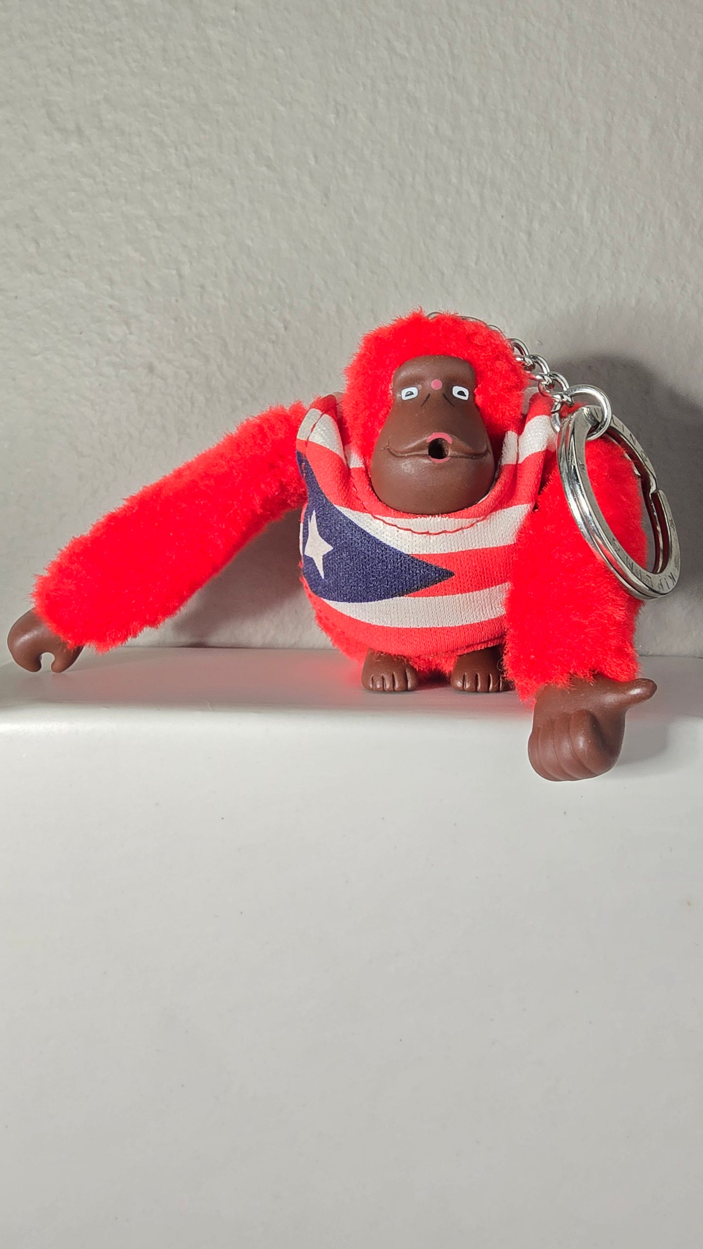 Kipling Red Fuzzy Monkey Keychain with Puerto Rico Flag Shirt